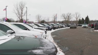 In this image made from video, cars drive through the used vehicle lot at a LaFontaine auto dealership in Fenton Township, Mich., Jan. 28, 2021. A chain reaction touched off by the coronavirus pandemic has pushed new-vehicle prices to record highs and dramatically driven up the cost of used ones.