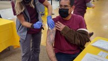 Anthony Martinez receives the first dose of his COVID-19 vaccine at the Chula Vista vaccination super station.
