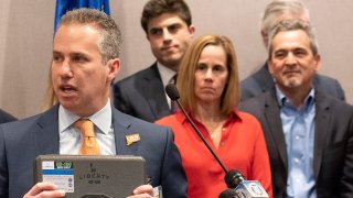 Jeremy Stein, executive director of CT Against Gun Violence, displays a gun safe or vault during a news conference on March 11, 2019, at the Legislative Office Building in Hartford, Conn. Michael Song, at right, and his wife, Kristen, center, along with legislators and gun-safety advocates are pushing for "Ethan's Law," to create state requirements for safe gun storage.