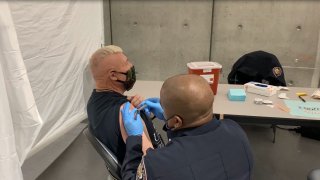 Homeless individual receiving the COVID-19 vaccine at the convention center