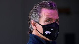 California Gov. Gavin Newsom wears a face mask as he prepares to give a briefing. (Photo by Patrick T. FALLON / AFP) (Photo by PATRICK T. FALLON/AFP via Getty Images)