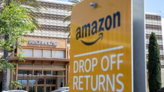 Amazon.com Inc. parking signage stands outside a Kohl’s Corp. department store in Huntington Beach, California, U.S., on Saturday, May 11, 2019.