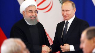 Russian President Vladimir Putin (R) greets Iran’s President Hassan Rouhani (L) during their meeting at the Grand Kremlin Palace on March 28, 2017 in Moscow, Russia.