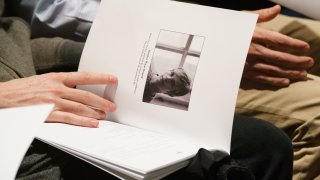 FILE - In this Oct. 26, 2018 file photo mourners hold programs with the image of Matthew Shepard during a "Thanksgiving and Remembrance of Matthew Shepard" service at Washington National Cathedral in Washington. Wyoming lawmakers have again decided not to adopt a hate crimes law in the state where gay college student Matthew Shepard was killed more than 20 years ago. Wyoming is one of just three states that haven't enacted hate crimes legislation since Shepard was beaten and left for dead in Laramie in 1998.