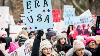 MANHATTAN, NY - JANUARY 18: A marcher holds a sign that say, "ERA USA" during the Woman's March in the borough of Manhattan in NY on January 18, 2020, USA. On April 15, 2020 Hulu is launching a series entitled "Mrs. America" which tells the story of the movement to ratify the Equal Rights Amendment (ERA), and the unexpected backlash led by a conservative woman named Phyllis Schlafly, Through the eyes of the women of the era -- both Schlafly and second-wave feminists Gloria Steinem, Betty Friedan, Shirley Chisholm, Bella Abzug and Jill Ruckelshaus -- the series explores how one of the toughest battlegrounds in the culture wars of the '70s helped give rise to the Moral Majority and forever shifted the political landscape.