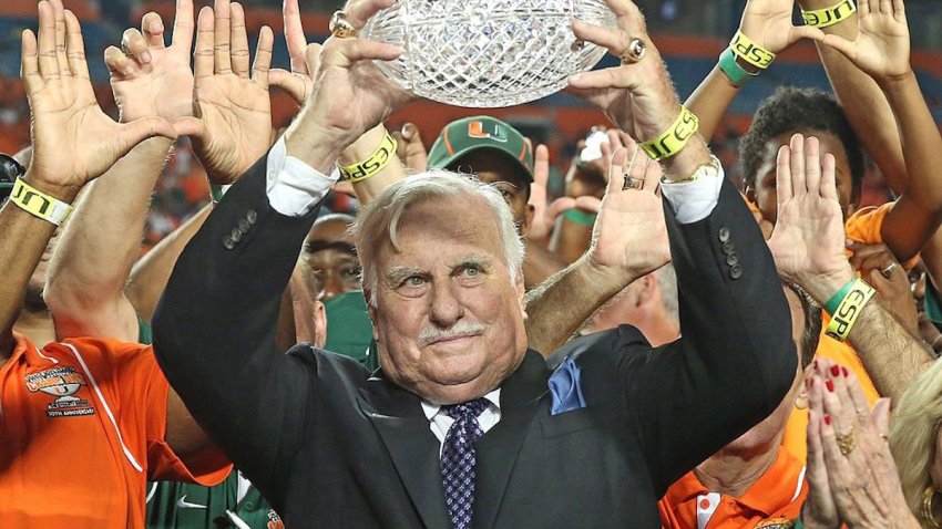 Former Miami coach Howard Schnellenberger raises the 1983 NCAA National Championship trophy during a halftime ceremony during action against Florida Atlantic at Sun Life Stadium in Miami Gardens, Florida, on Friday, August 30, 2013. (Al Diaz/Miami Herald/MCT)