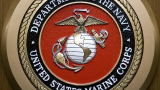 The US Department of the Navy, US Marine Corps, logo hangs on the wall February 24, 2009, at the Pentagon in Washington, DC.
