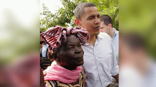 In this Saturday, Aug. 26, 2006, file photo, then U.S. Senator Barack Obama, right, walks with his grandmother Sarah Obama at his father's house in Kogelo village, western Kenya. Sarah Obama, the matriarch of former U.S. President Barack Obama's Kenyan family has died, relatives and officials confirmed Monday, March 29, 2021 but did not disclose the cause of death. She was at least 99 years old.