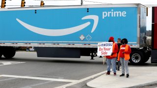 People hold a banner at the Amazon facility as members of a congressional delegation arrive to show their support for workers who will vote on whether to unionize, in Bessemer, Alabama, U.S. March 5, 2021.