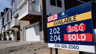 "Sold" signs sit on a lot as new home construction continue in a new neighborhood in Northbrook, Ill.