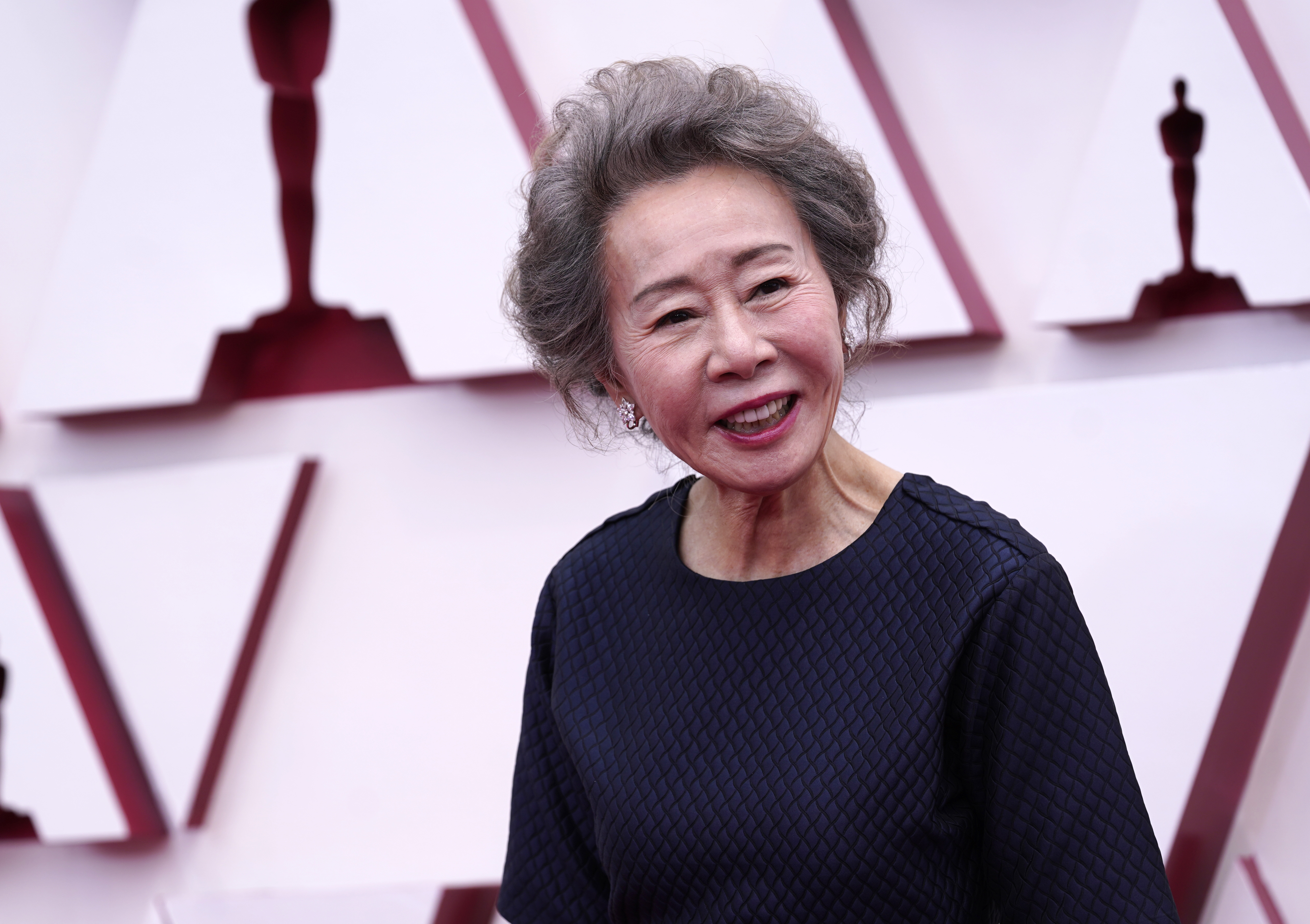 Youn Yuh-jung, who won best supporting actress for her role in "Minari," walks the red carpet.