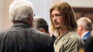 Edward "Jake" Wagner is arraigned at the Pike County Courthouse on Tuesday, Nov. 27, 2018 in Waverly, Ohio. The first of four family members charged with the 2016 shootings of seven adults and a teenager from the Rhoden family has pleaded not guilty to aggravated murder and other charges in the potential death penalty case. Wagner acknowledged the 23 counts against him but said little else. He is being held without bond.