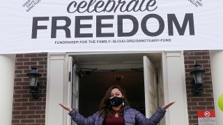 Vicky Chavez celebrates as she steps outside First Unitarian Church for the first time in 1,168 days as church congregants cheered celebrating her newfound freedom Thursday, April 15, 2021, in Salt Lake City. Chavez, a Honduran woman in the U.S. illegally who received sanctuary in a Salt Lake City church with her two young daughters for more than three years is now free to leave without risk of deportation.