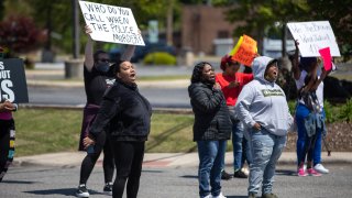 Demonstrators block an intersection to protest the police killing of Andrew Brown Jr in Elizabeth City, North Carolina on April 23, 2021. - Eyewitnesses say that Brown Jr. was shot and killed by Pasquotank County Sheriff deputies as he was attempting to evade them while they were serving him a warrant. The department has released few details over the incident as members of the community plead for transparency and the release of body cam footage.