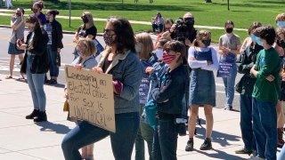Supporters of a 19-year-old legislative intern rally outside the Idaho Statehouse