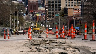 workers replace old water lines under Main Street as part of work to update water and sewer systems as well as prepare the road for the expansion of a street car line in Kansas City, Mo.