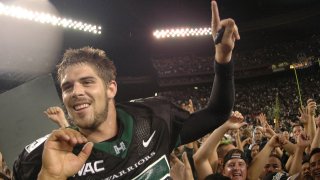 FILE - In this Nov. 23, 2007, file photo, then-Hawaii quarterback Colt Brennan celebrates after an NCAA college football game in Honolulu. Brennan, a star quarterback at the University of Hawaii who finished third in the 2007 Heisman Trophy balloting, died early Tuesday, May 11, 2021, his father said. He was 37. Brennan, who has had public struggles with alcohol, died at a hospital in California, his father, Terry Brennan, told The Associated Press.