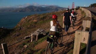 Visitors along the California Coastal Trail above the Golden Gate Bridge in San Francisco.