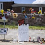 A memorial for David McAtee outside the location where he was shot and killed