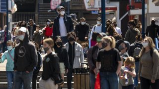 Pedestrians wearing protective masks walk on Pier 39 in San Francisco, California, U.S., on Thursday, April 8, 2021. California officials plan to fully reopen the economy on June 15, if the pandemic continues to abate, after driving down coronavirus case loads in the most populous U.S. state. Photographer: David Paul Morris/Bloomberg via Getty Images