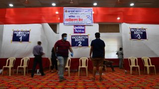 People are seen outside the booths at a Covid-19 coronavirus vaccination centre in Mumbai on May 9, 2021.