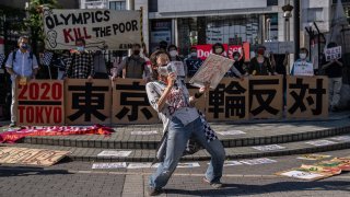 A protester shouts into a microphone during a demonstration against the forthcoming Tokyo Olympic Games on May 23, 2021 in Tokyo, Japan. IOC vice president John Coates told Tokyo 2020 Olympics organisers in a virtual news conference on Friday that the Games would open in just over two months even if Tokyo and other parts of Japan were under a state of emergency because of rising COVID-19 cases.