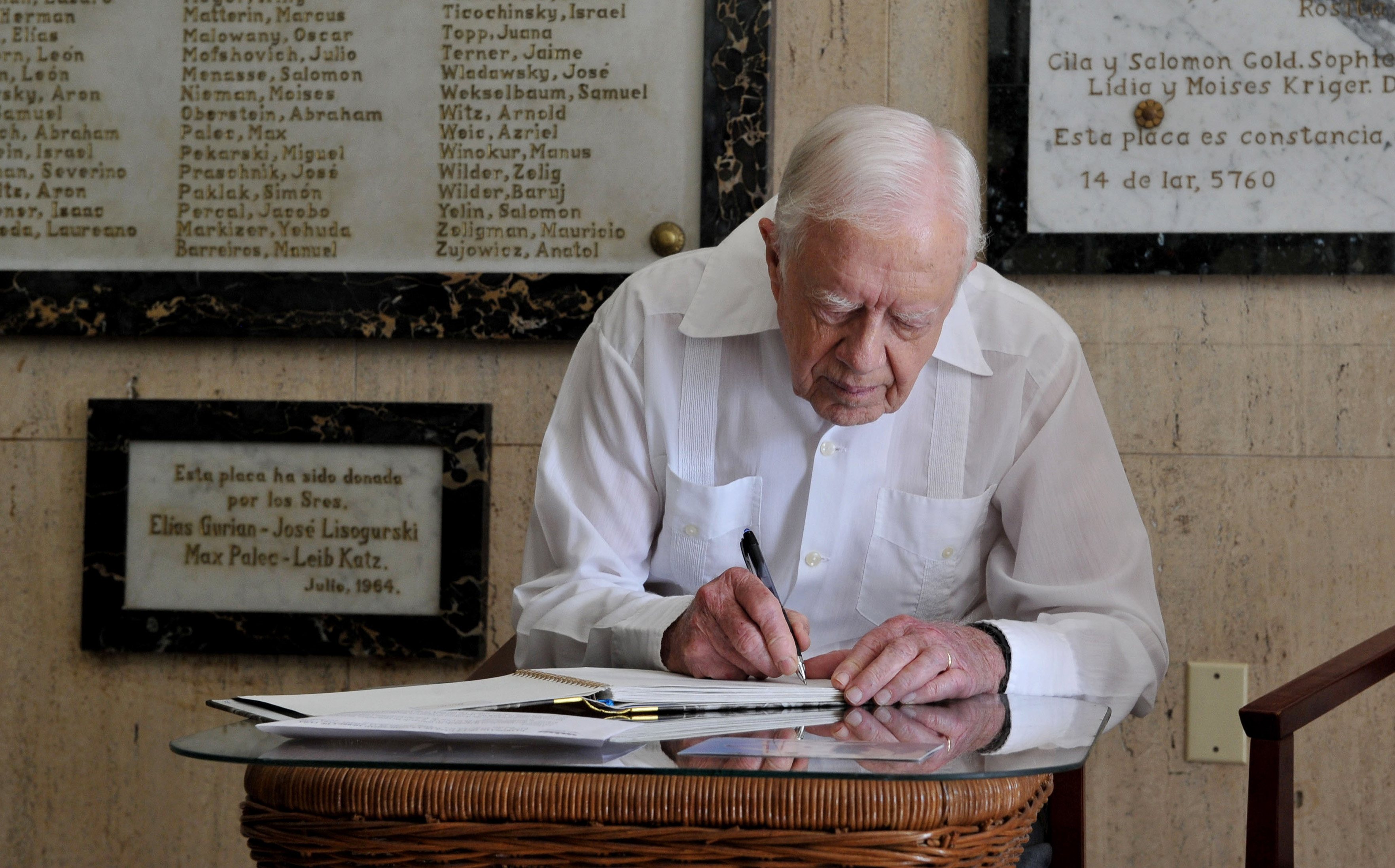 Former President Jimmy Carter signs his name in the guest book at the Jewish Community center in Havana, Cuba, March 28, 2011. Carter arrived in Cuba to discuss economic policies and ways to improve Washington-Havana relations, which were more tense than usual over the imprisonment of Alan Gross, a U.S. contractor, on the island.