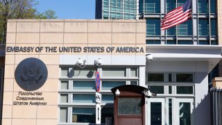 The U.S. Embassy and the National flag are seen in Moscow, Russia, Tuesday, May 11, 2021. Under Kremlin orders, the U.S. Embassy has stopped employing Russians, leaving Russian businessmen, lovers and exchange students adrift because they can't get visas and American parents are unable to register their newborns as citizens.