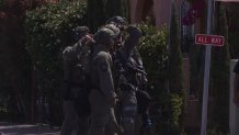 First responders in tactical gear respond to the scene of a standoff in Logan Heights on Friday, May 28, 2021.