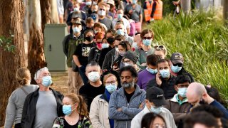 People queue outside a vaccination center in Sydney on June 24, 2021, as residents were largely banned from leaving the city to stop a growing outbreak of the highly contagious Delta Covid-19 variant spreading to other regions.