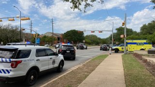 Police and emergency personnel work at the scene of a fatal shooting, Sunday, April 18, 2021, in Austin, Texas. Emergency responders say several people have been fatally shot in Austin and that no suspect is in custody. EMS spokeswoman Capt. Christa Stedman said early Sunday afternoon that it was still an active scene.