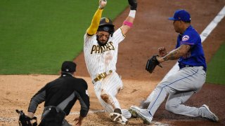SAN DIEGO, CA β JUNE 3: Fernando Tatis Jr. #23 of the San Diego Padres scores on a wild pitch ahead of the tag of Taijuan Walker #99 of the New York Mets during the fifth inning of a baseball game at Petco Park on June 3, 2021 in San Diego, California. (Photo by Denis Poroy/Getty Images)