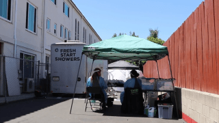 Think Dignity volunteers sit outside of Fresh Start Mobile Showers