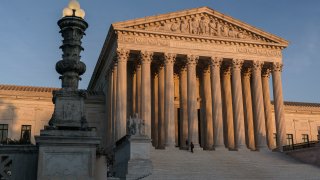 In this Nov. 6, 2020, file photo, the Supreme Court is seen at sundown in Washington. The state of California has agreed to pay more than $2 million in legal fees in a settlement with churches that challenged coronavirus closure orders. Church lawyers who successfully took their appeal to the U.S. Supreme Court said Wednesday, June 2, 2021, that the state agreed not to impose restrictions on houses of worship that are greater than those on retail businesses.