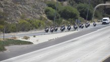 Police officers lead the way to the San Diego County Medical Examiner's Office on June 4, 2021 in a procession for two SDPD officers killed in a head-on collision in San Ysidro.