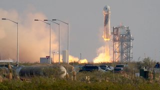 The New Shepard Blue Origin rocket lifts off.