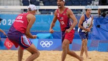 Nicholas Lucena, center, of the United States, celebrates with teammate Philip Dalhausser as Alvaro Morais Filho, right, of Brazil, watches during a men's beach volleyball match at the 2020 Summer Olympics, Tuesday, July 27, 2021, in Tokyo, Japan.