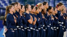 Members of team United States stand for their national anthem prior to a softball game against Japan at the 2020 Summer Olympics, Tuesday, July 27, 2021, in Yokohama, Japan.