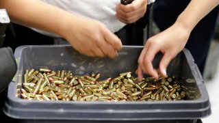 officers taking part in training load gun clips with ammunition