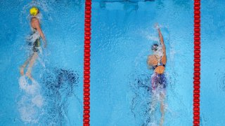 Ariarne Titmus, left, of Australia wins the final of the women's 400-meters freestyle ahead of Katie Ledecky, of the United States, at the 2020 Summer Olympics, Monday, July 26, 2021, in Tokyo, Japan.