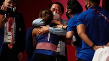 Hidilyn Diaz of Philippines celebrates with Weightlifting Philippines federation president Monico Puntuevella after winning the gold medal in the women's 55kg weightlifting event, at the 2020 Summer Olympics on July 26, 2021, in Tokyo, Japan.