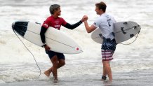 Japan's Kanoa Igarashi, left, shake hands with Kolohe Andino, of the United States, after wining the quarterfinals of the men's surfing competition at the 2020 Summer Olympics, Tuesday, July 27, 2021, at Tsurigasaki beach in Ichinomiya, Japan.