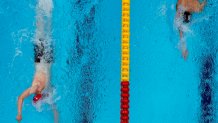 Tom Dean, of Britain and Kieran Smith, of the United States swim in the final of the men's 200-meter freestyle at the 2020 Olympics on July 27, 2021, in Tokyo, Japan.