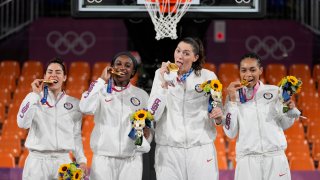 From left: Members of Team USA Kelsey Plum, Jacquelyn Young, Stefanie Dolson and Allisha Gray pose with their gold medals during the awards ceremony for women's 3-on-3 basketball at the 2020 Summer Olympics, Wednesday, July 28, 2021, in Tokyo, Japan. They became the first Olympians to win a gold medal in the women's 3x3 basketball category.