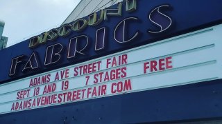 The iconic Discount Fabrics marquee displays the upcoming dates for the 40th Annual Adams Avenue Street Fair.