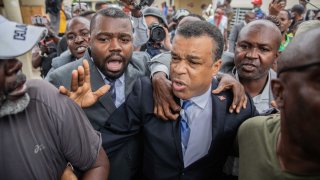 Former senator Steven Benoit (C) leaves the courthouse on July 12, 2021 in Port-au-Prince, Haiti. Prosecutors have asked senior political figures like Latortue to meet with officials for questioning as part of the investigation into the assassination of President Jovenel Moise.