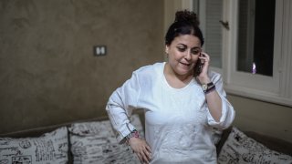 Egyptian activist and journalist Esraa Abdel Fattah speaks on the phone at her home after being released from prison.