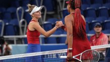 Czech Republic's Marketa Vondrousova (L) shakes hands with Japan's Naomi Osaka after winning their Tokyo 2020 Olympic Games women's singles third round tennis match at the Ariake Tennis Park in Tokyo on July 27, 2021.