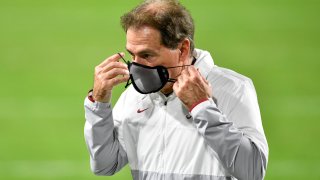 Head coach Nick Saban of the Alabama Crimson Tide puts his mask on during halftime of the College Football Playoff National Championship football game against the Ohio State Buckeyes at Hard Rock Stadium on January 11, 2021 in Miami Gardens, Florida.