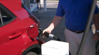 A person pumps gas in the Bay Area.